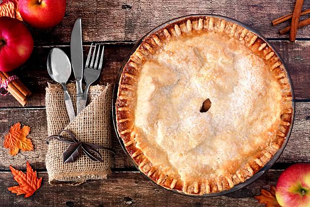 istock Apple autumn pie, overhead table scene over rustic wood 606740488