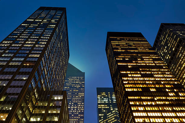 istock Low Angle View Of Illuminated Office Buildings Against Clear Sky 606758071