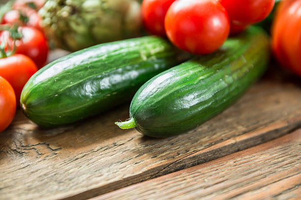 istock Close-Up Of Cucumbers And Tomatoes On Bench 606758969