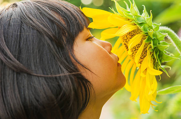 istock children with sunflower in nature 607253392