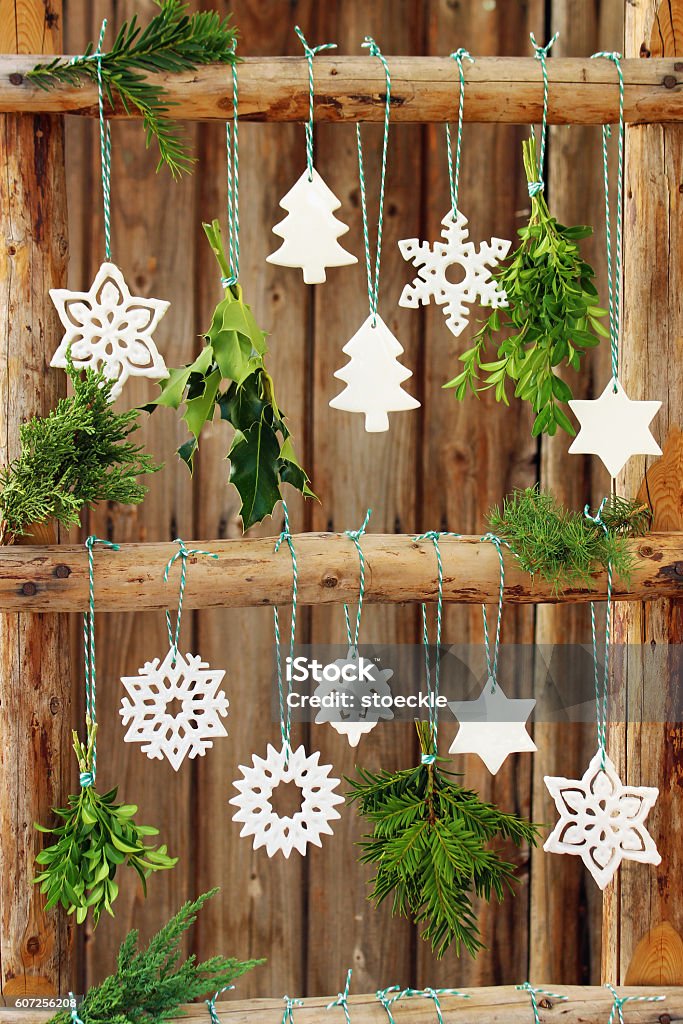 christmas ornaments Christmas decoration on an old wooden ladder with white ornaments and coniferous branches Ceramics Stock Photo
