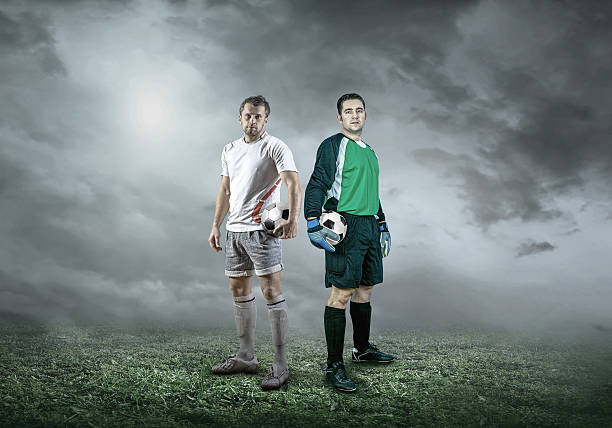 istock Football player with ball in action under sky with clouds 607257498