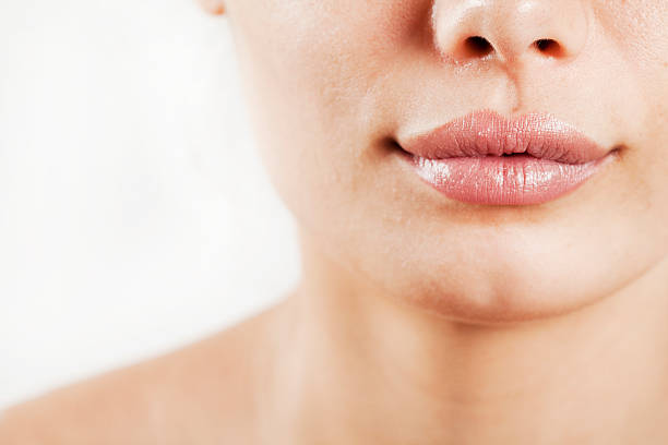 istock Beauty young woman lips 607260078