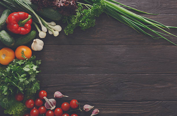 istock Border of fresh vegetables on wooden background with copy space 607262990