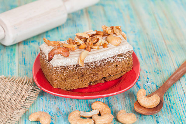 istock Coffee cake with cashew nut on wood table 607263026
