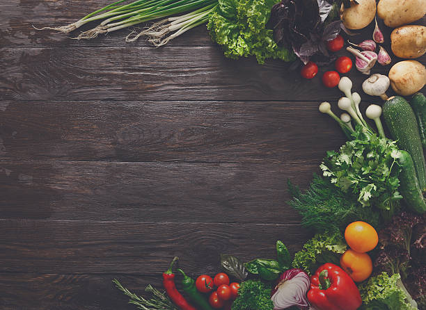 istock Border of fresh vegetables on wooden background with copy space 607263266