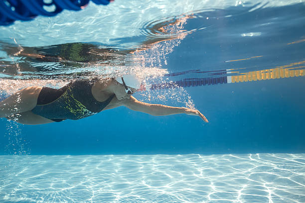 istock Woman swims underwater 607263590