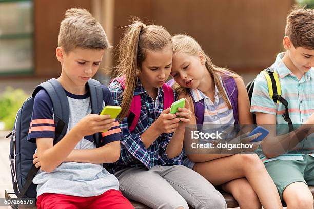 Elementary School Students With Smartphones Stock Photo - Download Image Now - Child, Mobile Phone, Smart Phone