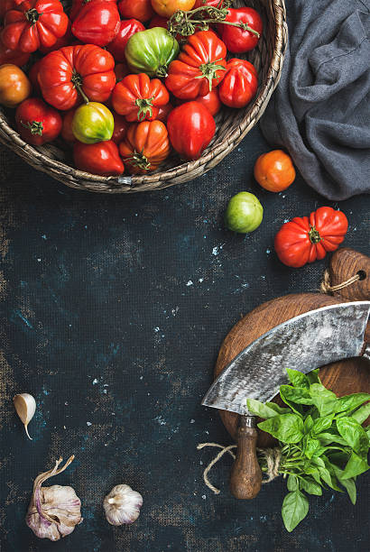 istock Fresh colorful ripe heirloom tomatoes in basket, copy space 607267484