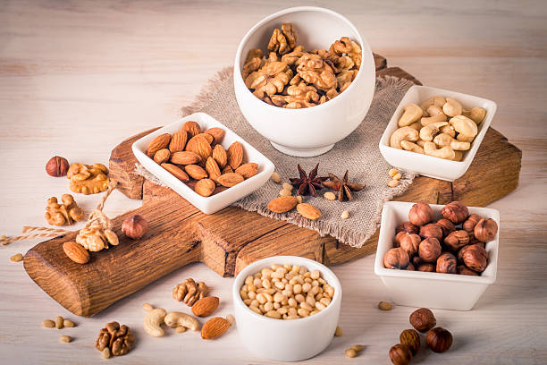 istock almonds, walnuts, hazelnuts cashews and pine nuts in wooden bowl 607268426