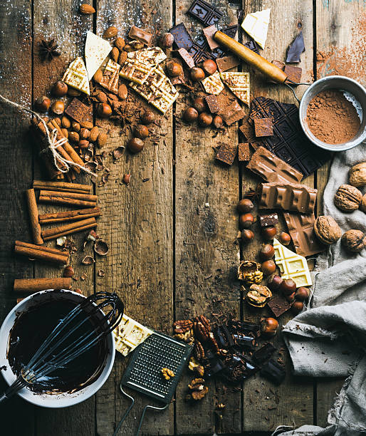 istock Hot chocolate cooking ingredients over rustic wooden background, copy space 607269292