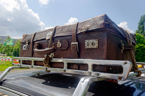 istock Old suitcase on the car roof rack 607269618
