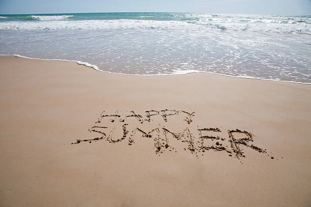 istock happy summer text in sand beach with ocean 607270610