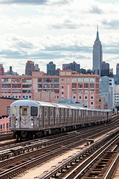 istock Subway Train Speeding on Elevated Track in Queens, New York 607270780
