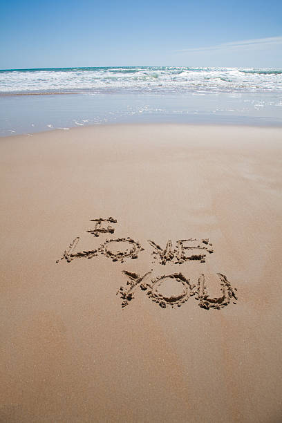 istock i love you text at beach 607271438