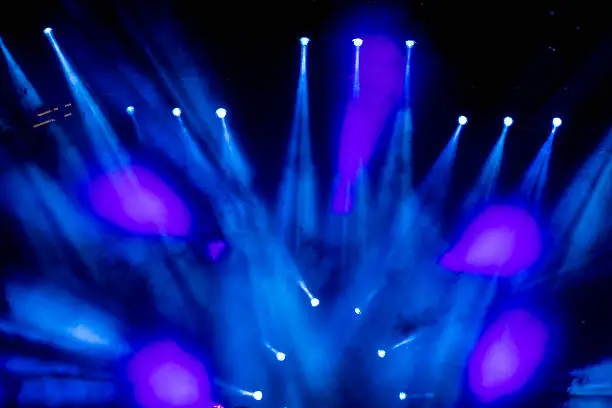 Photo of Defocused entertainment concert lighting on stage, bokeh