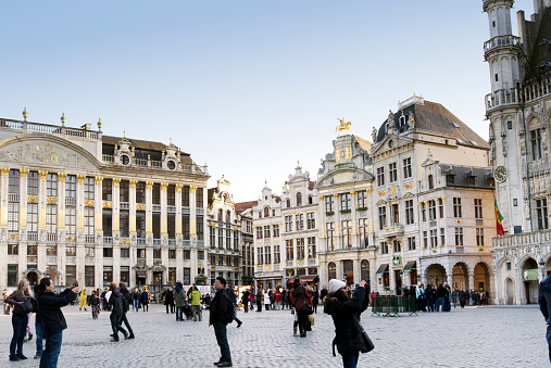 Brussels,Belgium - January 27, 2012: Tourists visiting the famous Grand Place in the heart of Brussels.The historical Grand Place with elaborated guild houses is an Unesco World Heritage Site 