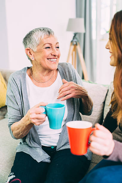 istock Mother and daughter drinking coffee 607273416