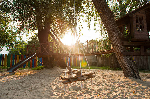 playground with a hanging swing plane in the evening