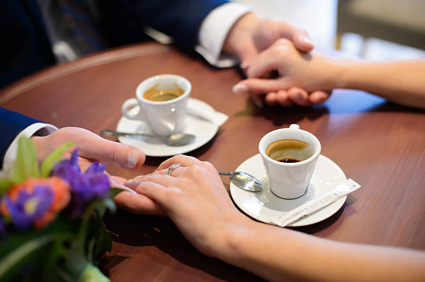 istock Lovers drinking coffee out of cups in the cafe. 607274174