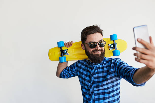 istock bearded hipster taking selfie with smartphone 607275912