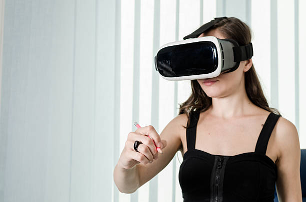 istock Girl have Fun Drawing with a Pencil Into Virtual Reality 607276488
