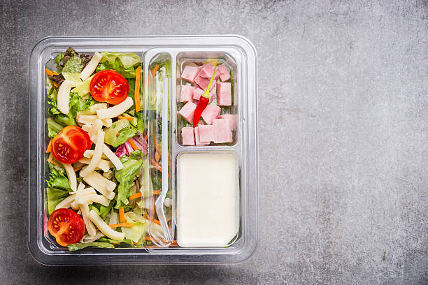 istock Lunch box with lettuce salad with cheese ,ham and yogurt 607279996