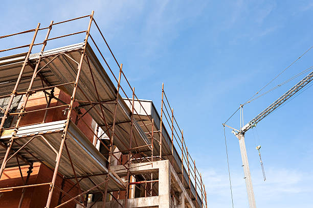 istock House for renovation with the scaffolding for bricklayers 607280668