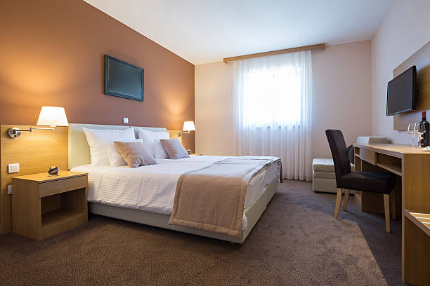 istock Modern beautiful double bed hotel bedroom interior 607281072