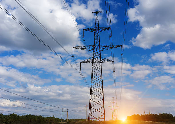 istock tower of power lines and electrical wires, clouds at sunset. 607283464