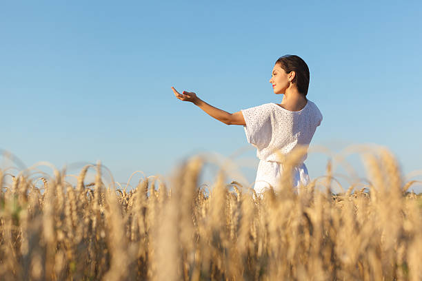 istock girl in wheat field 607284130