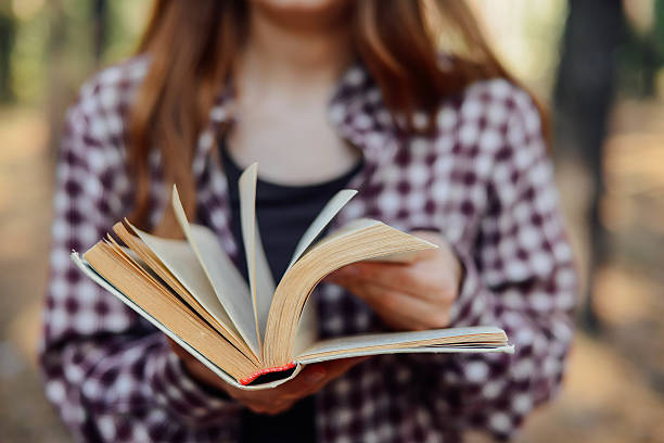 istock hand turning pages of a book. 607285060