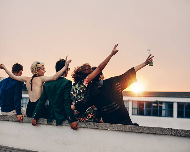 istock Young people partying on terrace with drinks 607285346