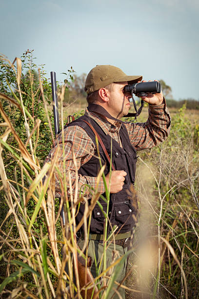 istock Hunter On The Outlook In The Forest Meadow 607286412