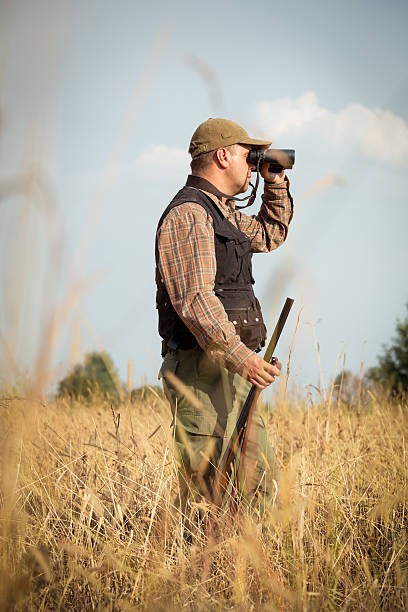 istock Hunter On The Outlook In The Forest Meadow 607286486