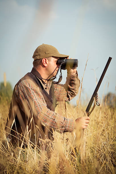 istock Hunter On The Outlook In The Forest Meadow 607286660