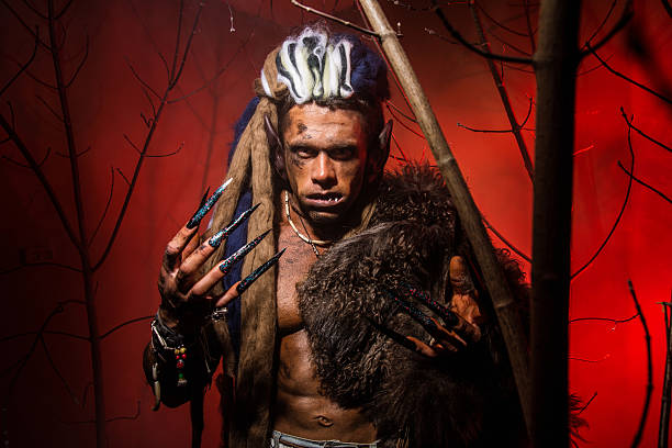 istock Werewolf with long nails and crooked teeth among the branches 607286812