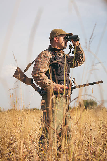istock Hunter On The Outlook In The Forest Meadow 607286916