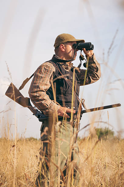 istock Hunter On The Outlook In The Forest Meadow 607287422