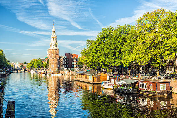 istock Amsterdam Canal with houseboats and ships 607287930