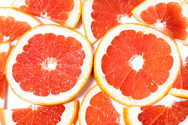 istock Slices of grapefruit on a white background 607288250