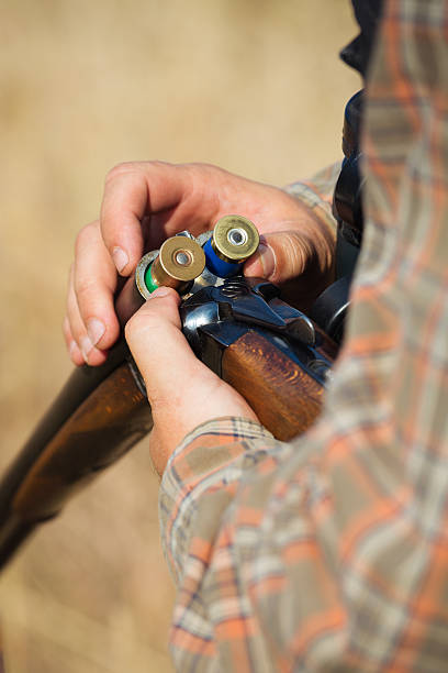 istock Close-up of a hunter loading his shotgun 607288466