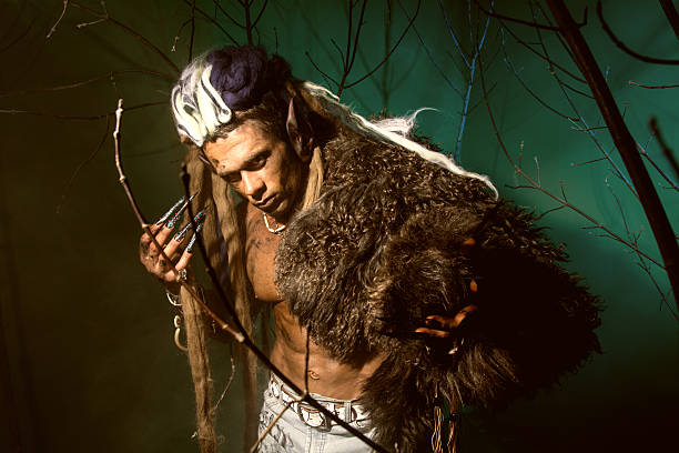 istock Muscular man with skin and dreadlocks among the trees 607292278