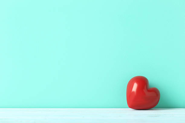 istock Red heart on blue wooden table 607292988