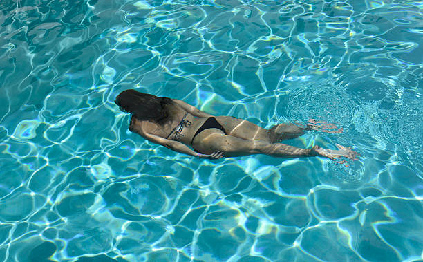 istock Woman Relaxing in the Pool 607294126