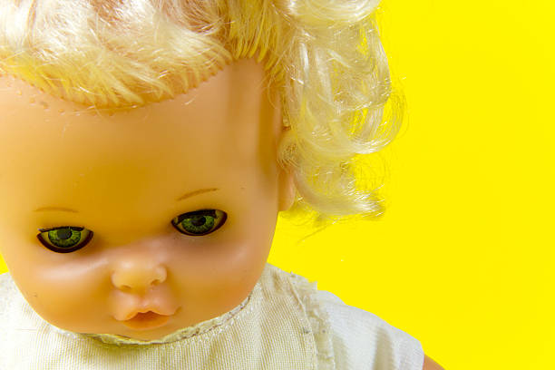 istock vintage doll, dolly, puppet,  old toy, retro, yellow background , blue 607295102