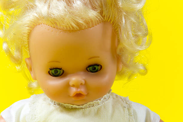istock vintage doll, dolly, puppet,  old toy, retro, yellow background , blue 607295274