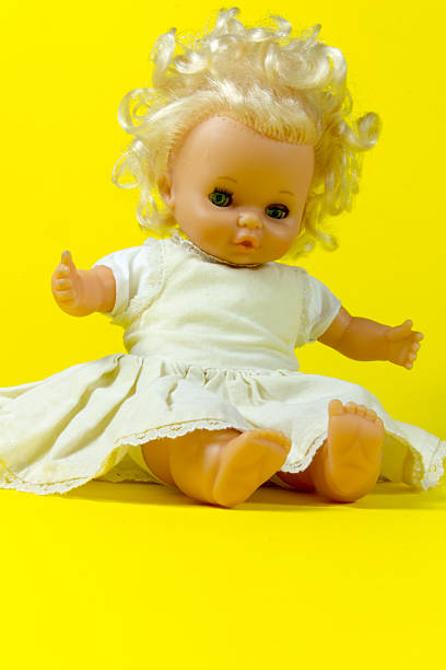 istock vintage doll, dolly, puppet,  old toy, retro, yellow background , blue 607295576