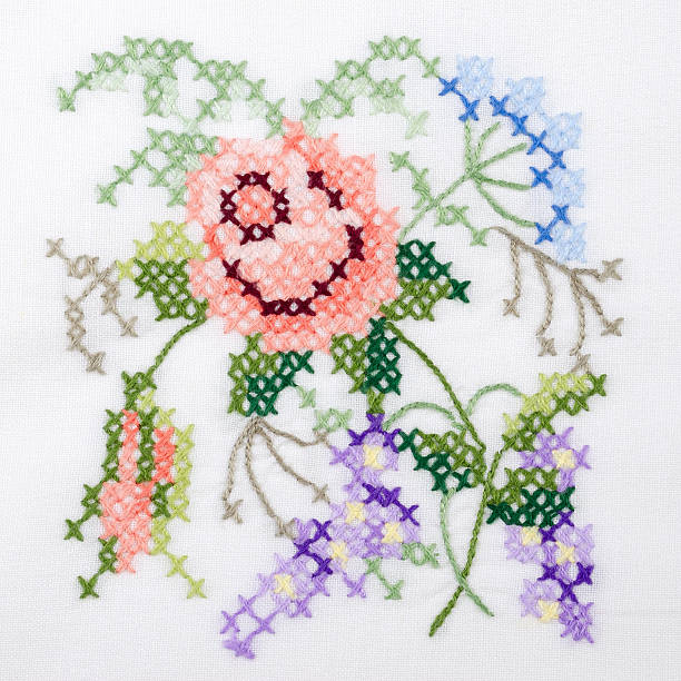 istock Flowers motif hand embroidery on white linen tablecloth 607296728