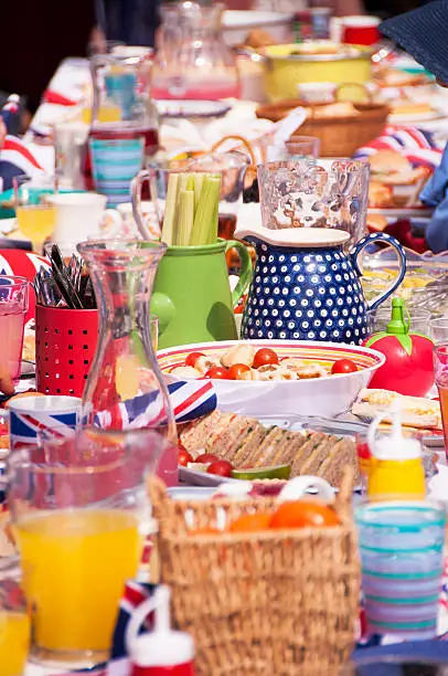 Long table of party food and drink from a street party in Great Britain.
